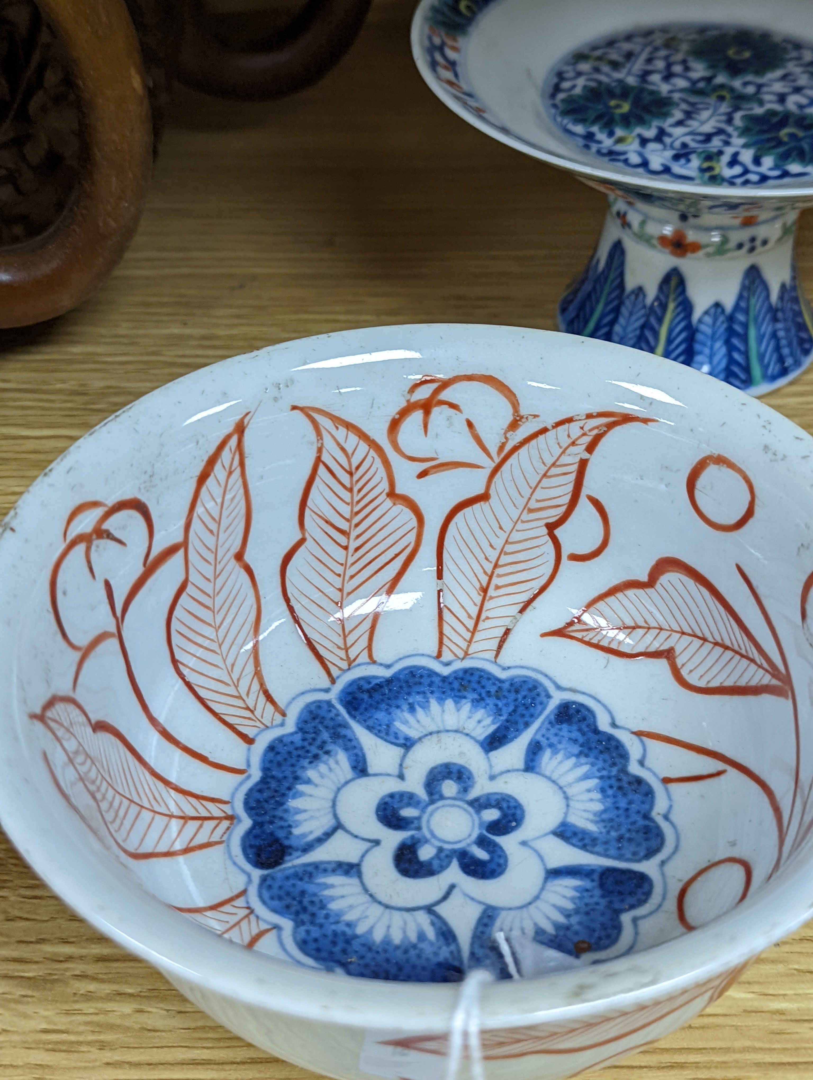 A Chinese blue and white water pipe vessel, a doucai stem dish and a Japanese Imari bowl, 19th century, (3)